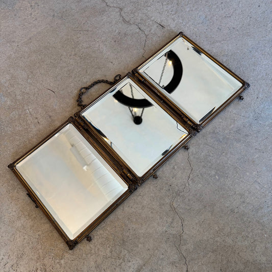 Trifold vanity mirror open, showing three beveled panels
